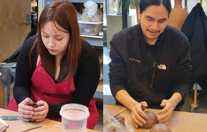 Students molding clay during pottery class.